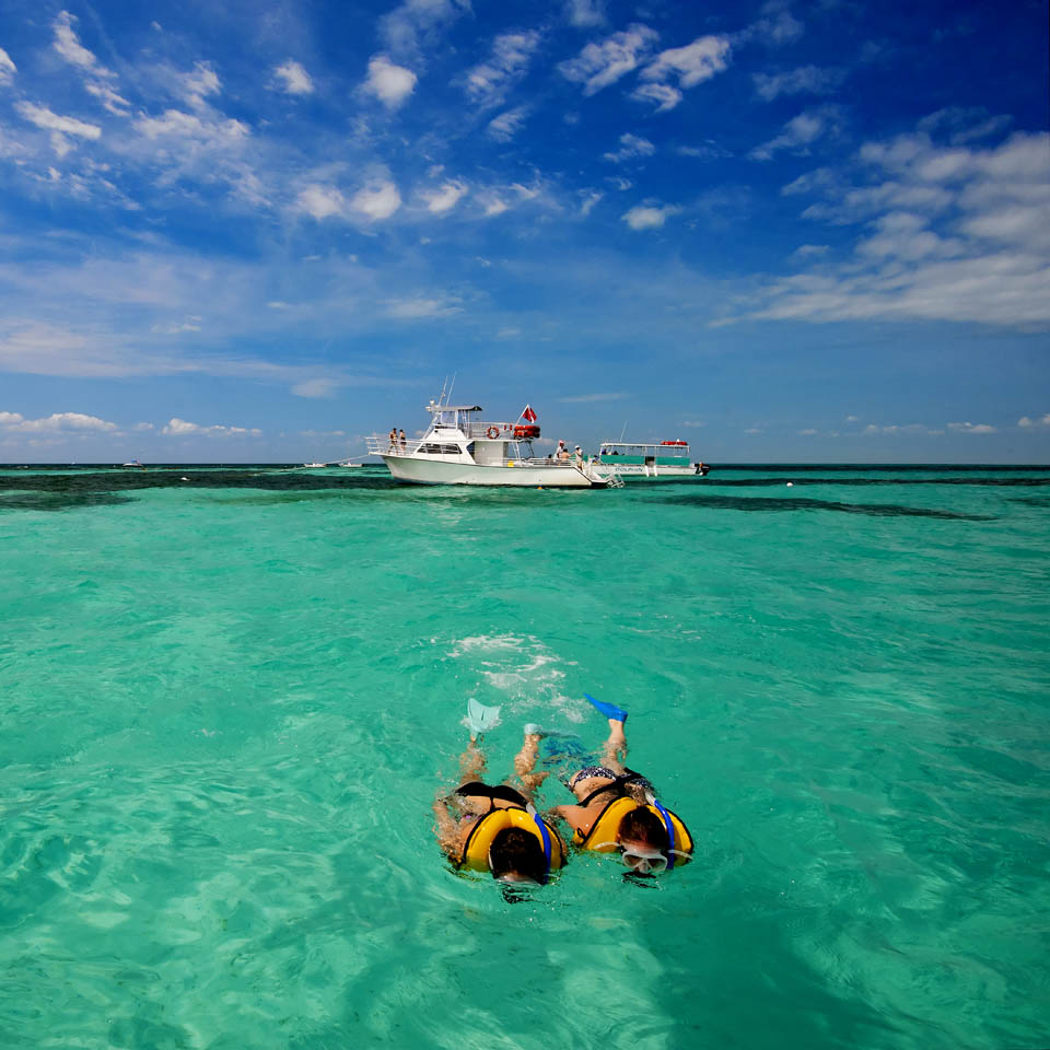 A couple snorkel in the clear waters of Key Largo