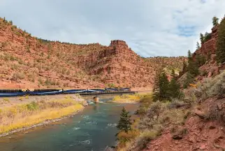 Canyon Spirit train travels through red rock valleys